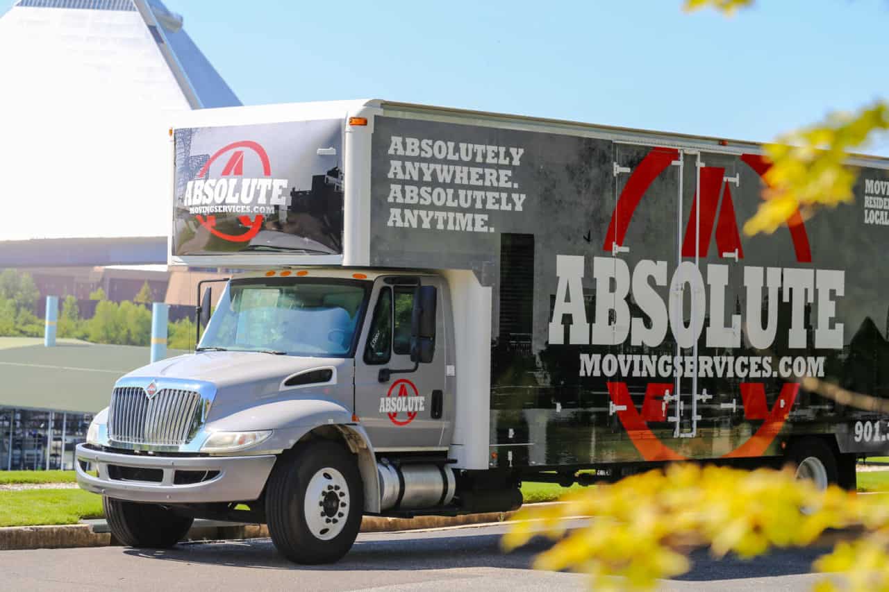 An Absolute Moving Services truck parked near the Memphis Pyramid
